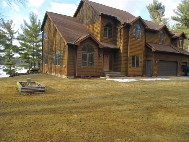 view of front of home with a garage, driveway, and a front yard