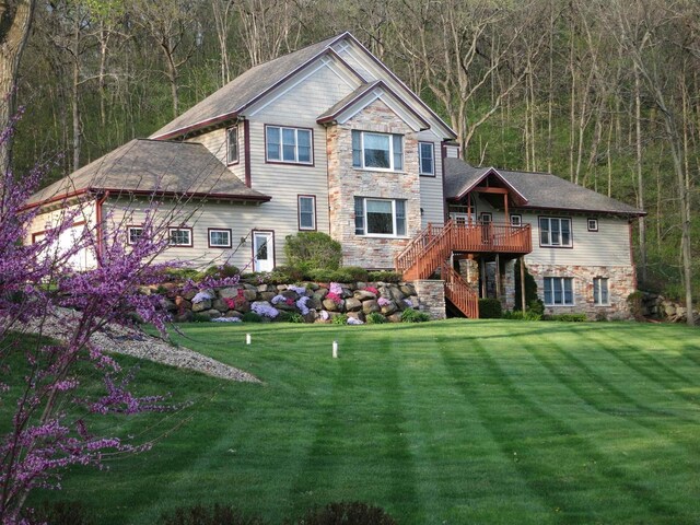 4494 Oak Valley Rd, Cross Plains, WI 53528 - view of front facade featuring stairway, a forest view, stone siding, and a front lawn