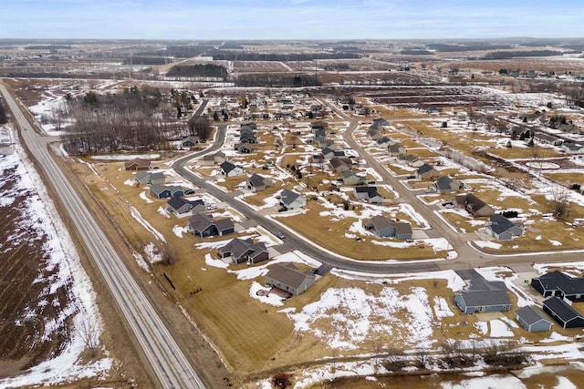 snowy aerial view with a residential view