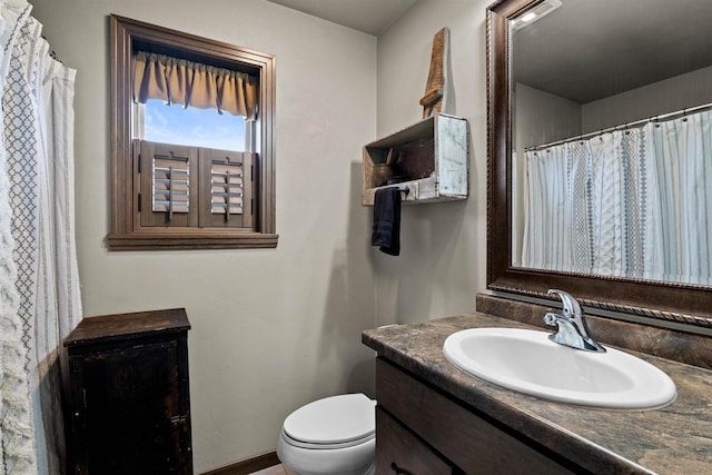 full bath featuring vanity and toilet