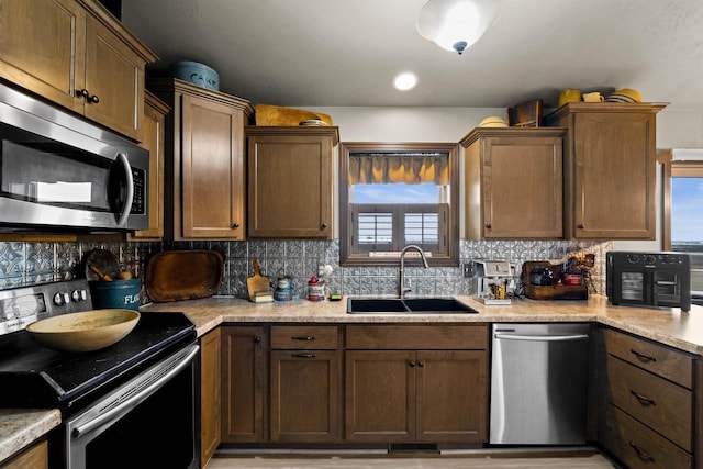 kitchen featuring tasteful backsplash, visible vents, appliances with stainless steel finishes, light countertops, and a sink