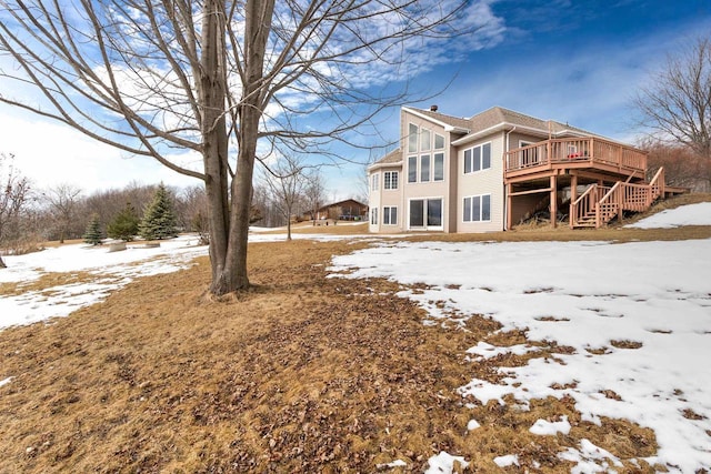 snow covered property featuring a deck