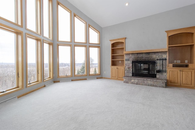 unfurnished living room with light carpet, a fireplace, a towering ceiling, and visible vents