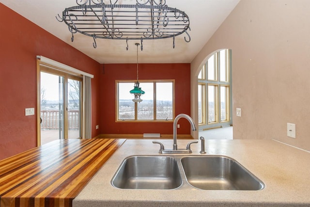 kitchen featuring pendant lighting, light countertops, and a sink