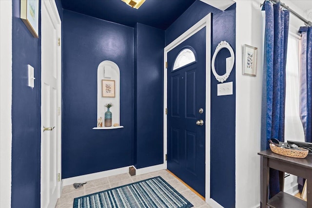 entryway featuring tile patterned flooring and baseboards