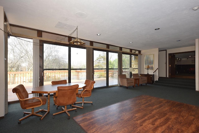 dining area with carpet floors and floor to ceiling windows