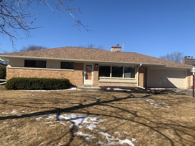 single story home featuring roof with shingles, brick siding, a chimney, and an attached garage