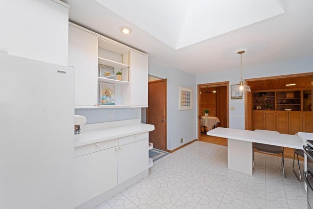 kitchen featuring visible vents, decorative light fixtures, light countertops, white cabinetry, and open shelves