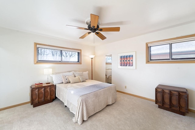 carpeted bedroom with a ceiling fan and baseboards