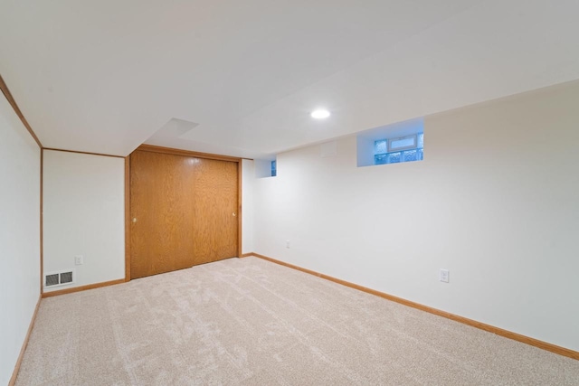 finished basement featuring carpet, visible vents, baseboards, and recessed lighting