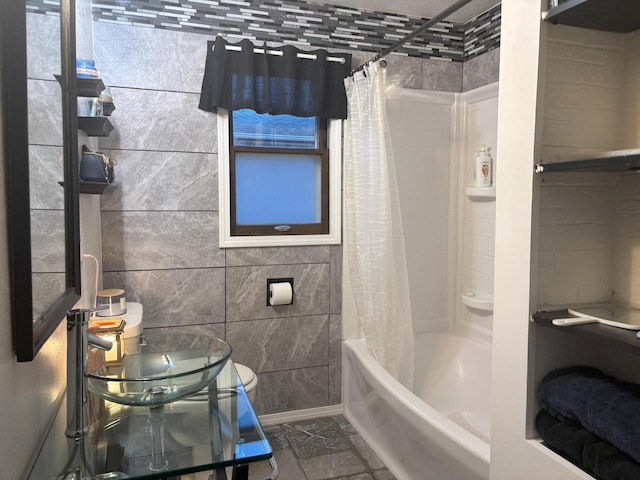 full bath with shower / bath combo and tile walls