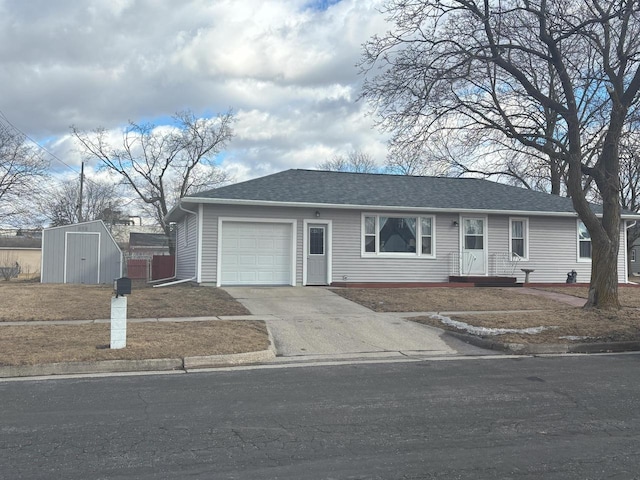 ranch-style house featuring an outbuilding, an attached garage, a storage shed, a shingled roof, and concrete driveway