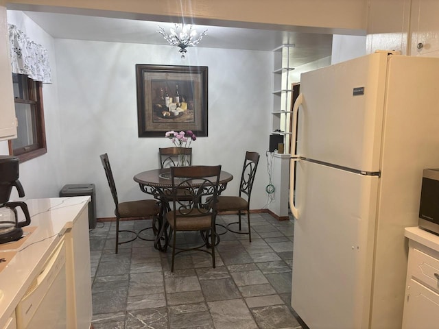 dining room featuring stone finish flooring and baseboards