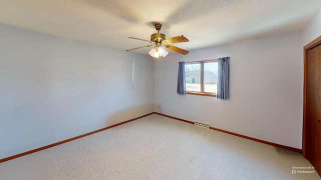 unfurnished room featuring visible vents, light carpet, ceiling fan, a textured ceiling, and baseboards