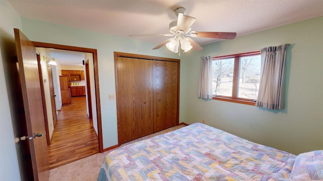 bedroom with a closet, a ceiling fan, and baseboards