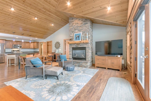 N8111 Castaway Dr, New Lisbon, WI 53950 - living room with high vaulted ceiling, wooden ceiling, a fireplace, and light wood-style flooring