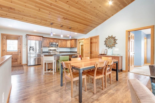N8111 Castaway Dr, New Lisbon, WI 53950 - dining area with light wood-style floors, wood ceiling, baseboards, and high vaulted ceiling