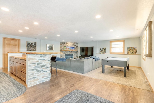 N8111 Castaway Dr, New Lisbon, WI 53950 - rec room with light wood-style flooring, a fireplace, baseboards, and recessed lighting