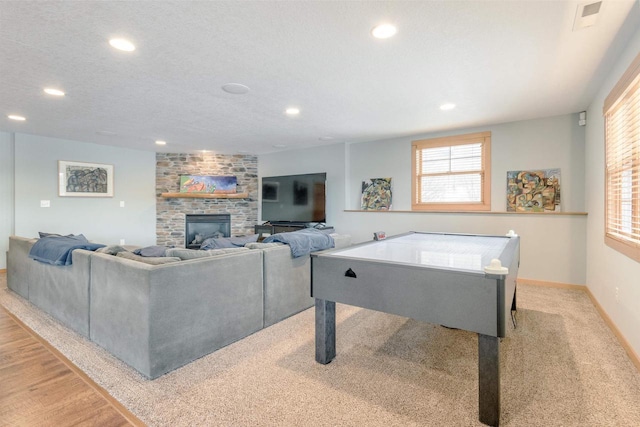 N8111 Castaway Dr, New Lisbon, WI 53950 - rec room featuring a textured ceiling, a fireplace, and recessed lighting