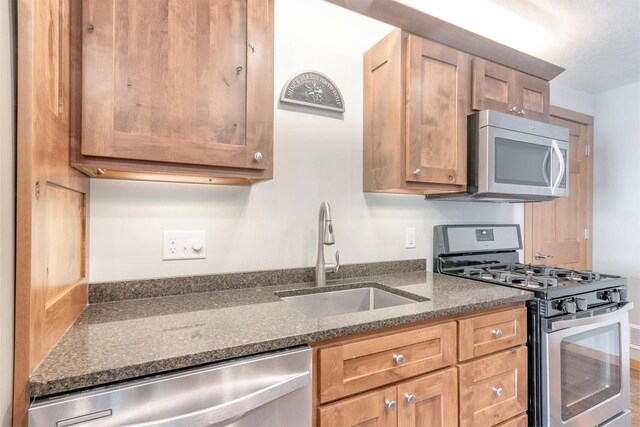 N8111 Castaway Dr, New Lisbon, WI 53950 - kitchen with stainless steel appliances, a sink, and dark stone countertops