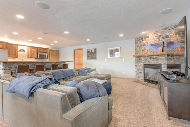 N8111 Castaway Dr, New Lisbon, WI 53950 - living room with light carpet, a textured ceiling, a fireplace, and recessed lighting