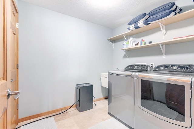N8111 Castaway Dr, New Lisbon, WI 53950 - clothes washing area featuring a textured ceiling, laundry area, separate washer and dryer, and baseboards