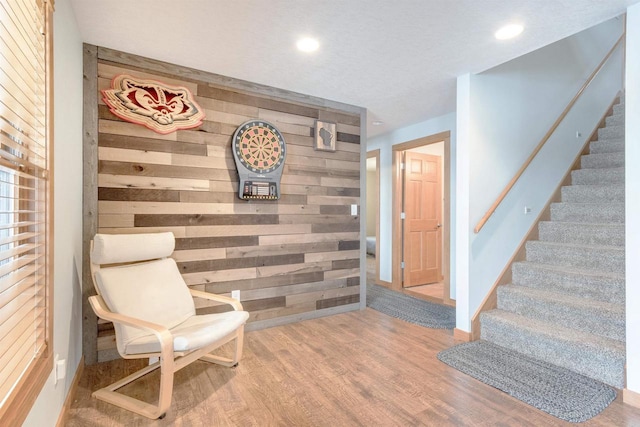 N8111 Castaway Dr, New Lisbon, WI 53950 - sitting room featuring an accent wall, recessed lighting, wooden walls, and wood finished floors