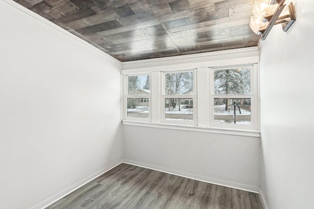 empty room featuring wooden ceiling, baseboards, and dark wood finished floors