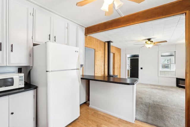 kitchen featuring ceiling fan, white appliances, dark countertops, and white cabinets