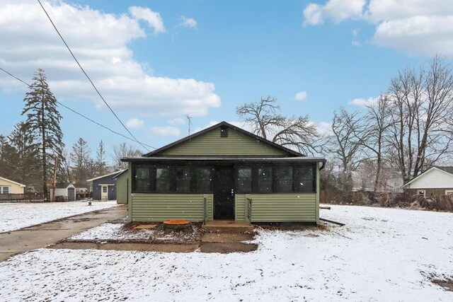 bungalow-style house with a sunroom