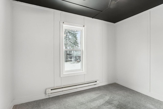 carpeted empty room featuring baseboard heating