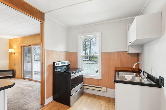 kitchen featuring a baseboard radiator, electric range, a sink, white cabinetry, and dark countertops