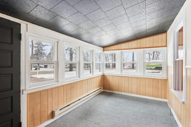 unfurnished sunroom featuring lofted ceiling and baseboard heating