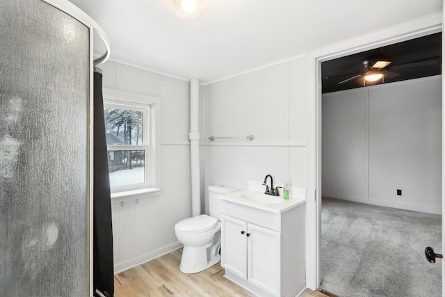 bathroom featuring toilet, wood finished floors, and vanity