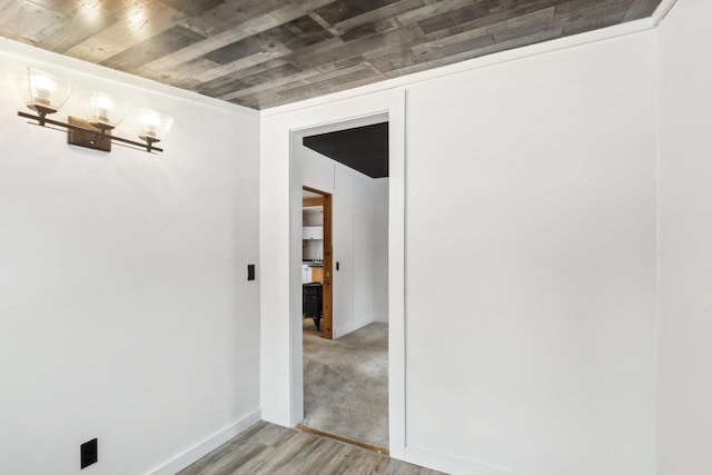 empty room with light wood-type flooring and baseboards