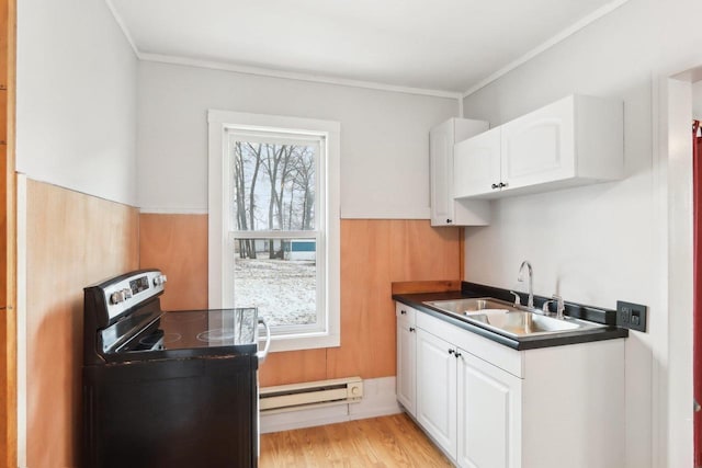 kitchen featuring dark countertops, stainless steel electric range oven, a baseboard heating unit, white cabinetry, and a sink