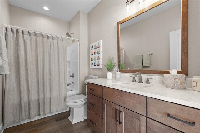 bathroom featuring shower / tub combo, vanity, toilet, and wood finished floors