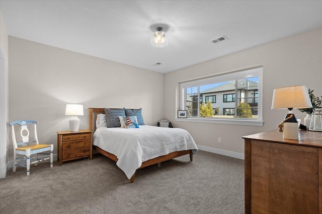 carpeted bedroom featuring visible vents and baseboards