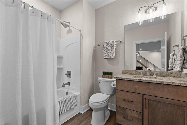 bathroom with toilet, wood finished floors, vanity, baseboards, and shower / bath combo with shower curtain