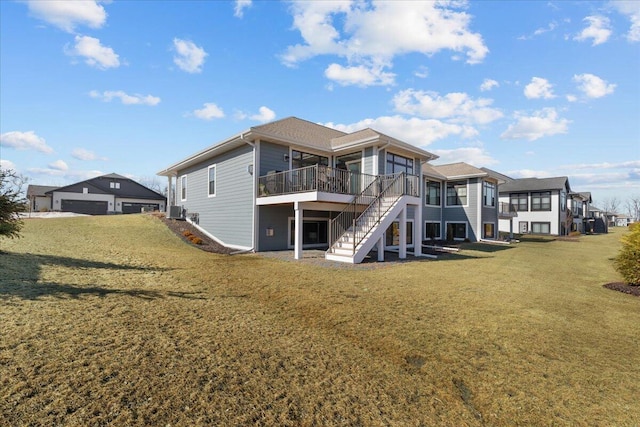 rear view of house with stairs, a lawn, a wooden deck, and central air condition unit