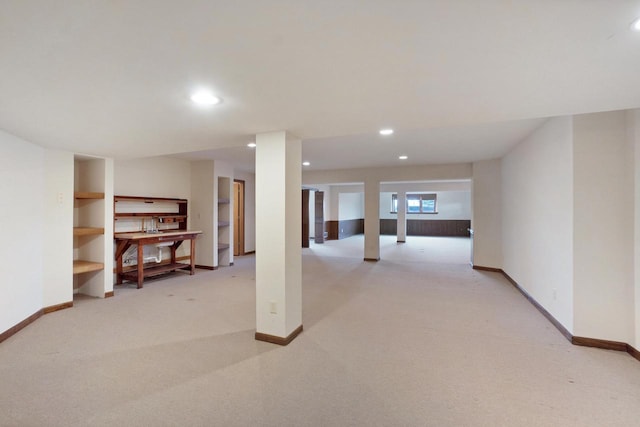 basement featuring recessed lighting, light colored carpet, and baseboards