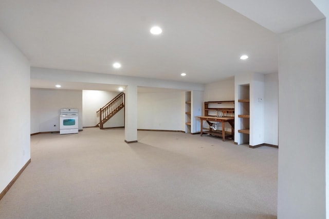 finished basement featuring recessed lighting, light carpet, and baseboards