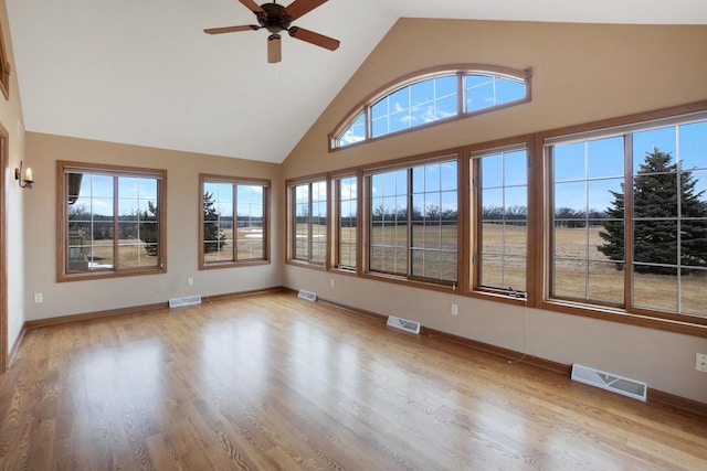 unfurnished sunroom featuring visible vents and vaulted ceiling