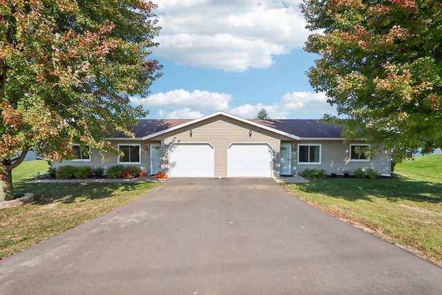 single story home with an attached garage, driveway, and a front lawn