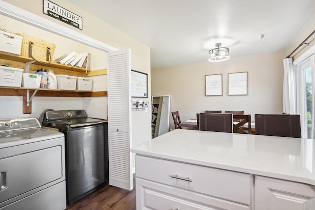 kitchen with white cabinets, dark wood-style floors, light countertops, washer and dryer, and open shelves