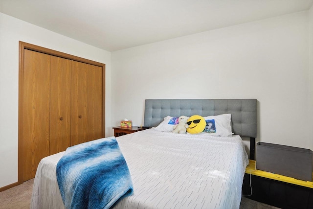 bedroom featuring carpet, a closet, and baseboards