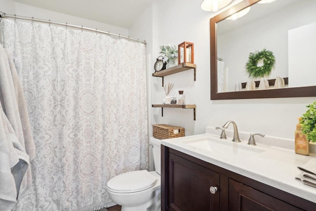 bathroom with toilet, a shower with curtain, and vanity