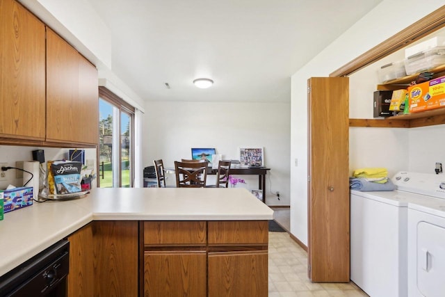 kitchen with washing machine and dryer, a peninsula, light countertops, dishwasher, and light floors