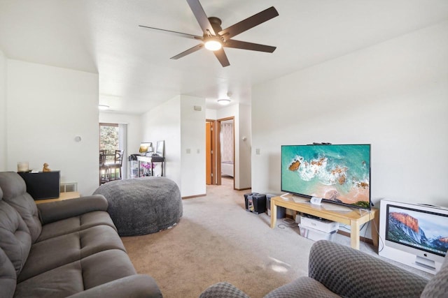 carpeted living area featuring ceiling fan, visible vents, and baseboards