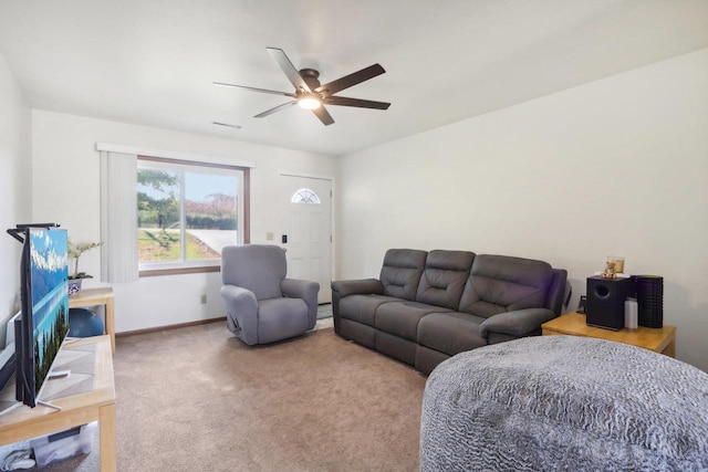 living area with carpet flooring, a ceiling fan, and baseboards